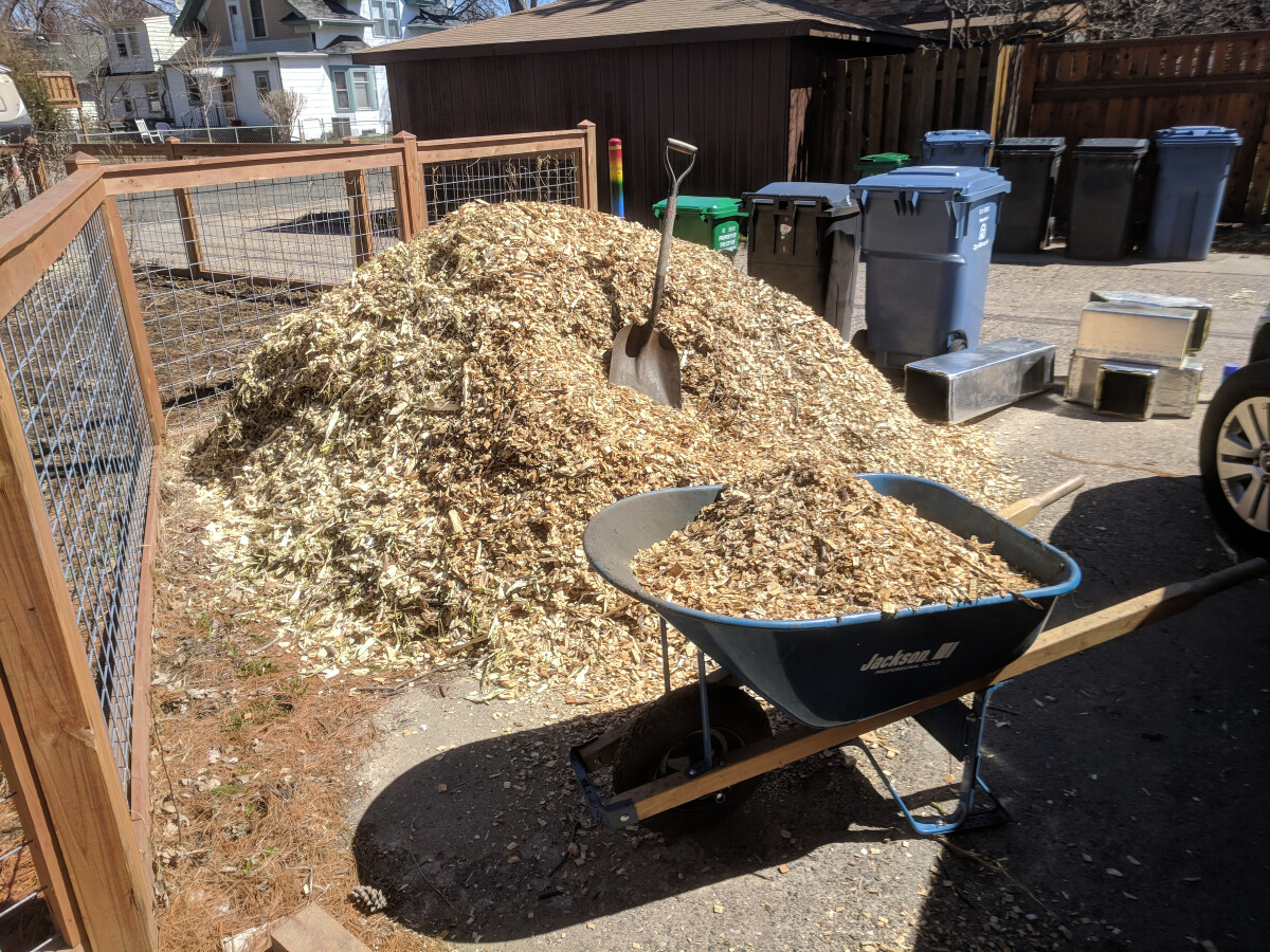 A giant pile of wood chips in the driveway