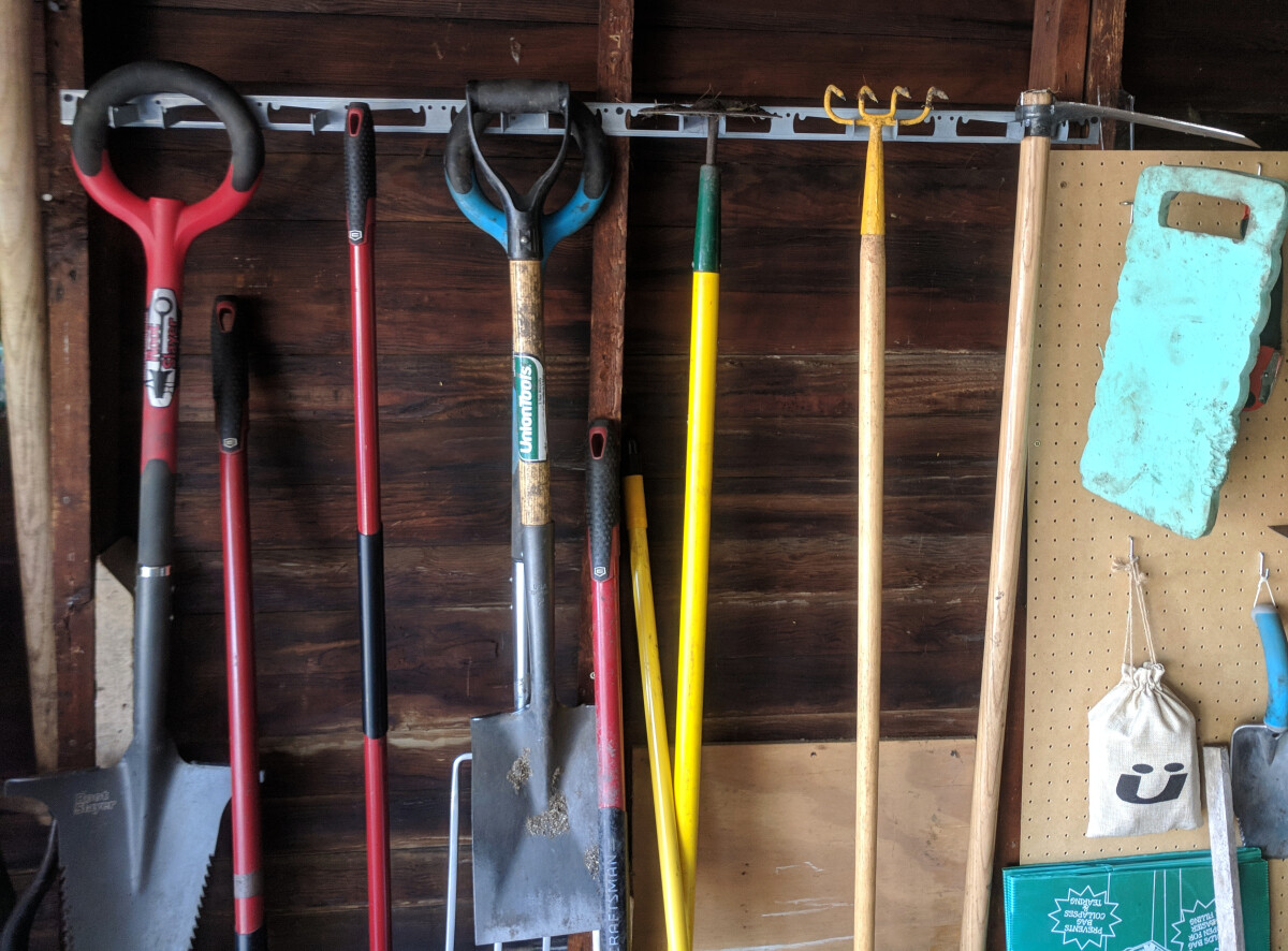 Large garden tools on hanging rack