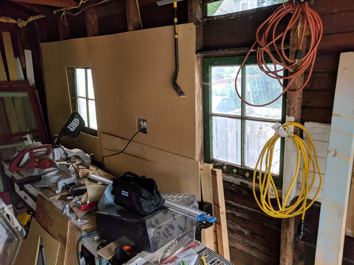 Pegboard with cutouts for the window and outlet box