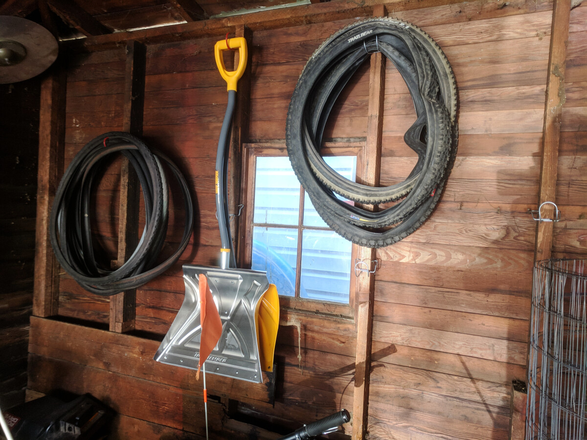 Storage hooks holding tires and shovels