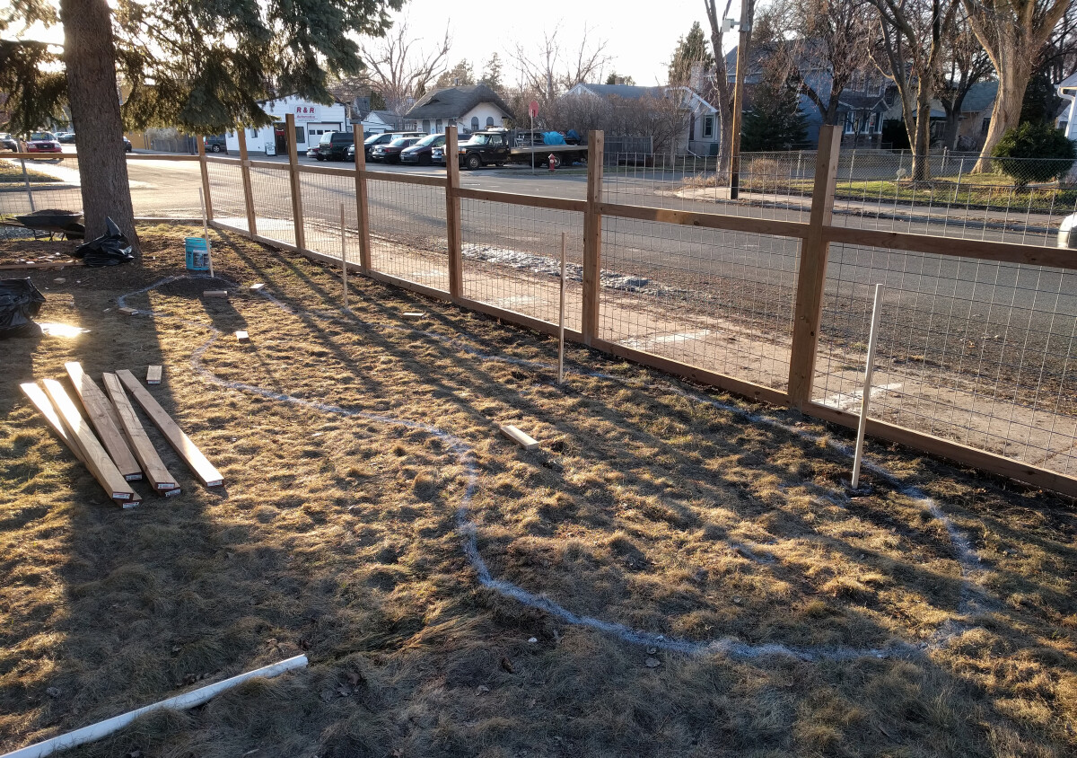 Grass spray-painted with outline of rain garden