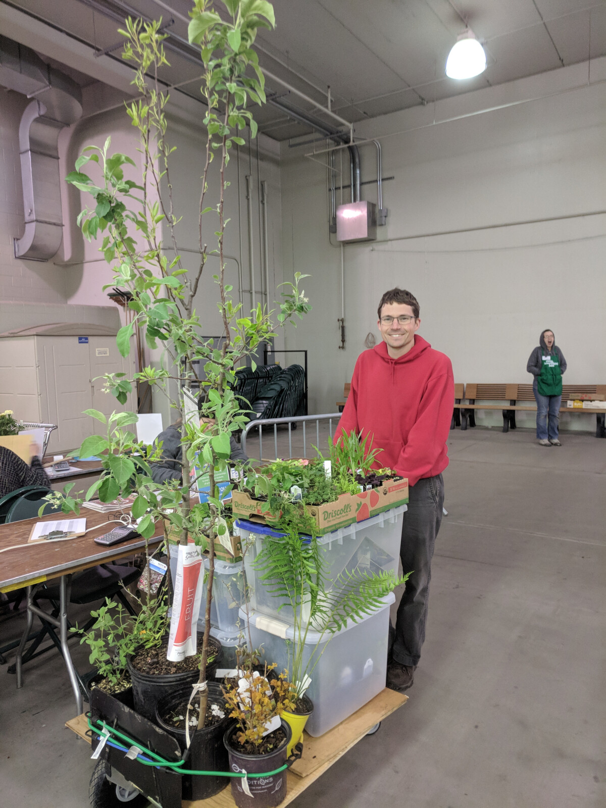 Ian with a cart overloaded with plants